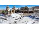 Exterior of a luxurious castle-style home in a snowy landscape at 3120 Bears Den Dr, Sedalia, CO 80135