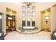 Bright bathroom with a soaking tub, travertine floors, and a wall of windows at 3120 Bears Den Dr, Sedalia, CO 80135