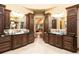 Bathroom featuring dual sinks and dark wood cabinetry at 3120 Bears Den Dr, Sedalia, CO 80135