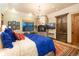Charming bedroom with stone fireplace, chandelier and area rug at 3120 Bears Den Dr, Sedalia, CO 80135