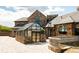 Beautiful stone home with a unique glass-enclosed greenhouse attached, offering natural light at 3120 Bears Den Dr, Sedalia, CO 80135