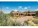 Stone castle-style home with landscaping and driveway at 3120 Bears Den Dr, Sedalia, CO 80135