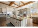 Spacious kitchen with a large center island, stainless steel appliances, and exposed beams at 3120 Bears Den Dr, Sedalia, CO 80135