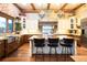 Beautiful kitchen featuring a large island with barstool seating, custom cabinets, and stone accents at 3120 Bears Den Dr, Sedalia, CO 80135