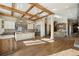 Open kitchen with a large island, stone accents, custom cabinets, stainless appliances, and hardwood floors at 3120 Bears Den Dr, Sedalia, CO 80135