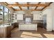Bright kitchen with an island, custom cabinets, stainless steel appliances, and hardwood floors at 3120 Bears Den Dr, Sedalia, CO 80135