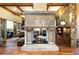 Living room with a stone fireplace, wood floors, built-in shelving, and a large sliding glass door at 3120 Bears Den Dr, Sedalia, CO 80135