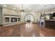 Open-concept living space with stone fireplace, bar, and dining area at 3120 Bears Den Dr, Sedalia, CO 80135