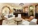 Basement living area with stone archways, bar, and cozy seating at 3120 Bears Den Dr, Sedalia, CO 80135