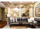 Elegant living room features stone arches, fireplace and comfortable brown leather sofa at 3120 Bears Den Dr, Sedalia, CO 80135