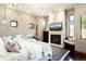 A cozy main bedroom features a brick wall, fireplace, and seating area with large windows at 3120 Bears Den Dr, Sedalia, CO 80135