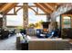 Outdoor patio with fireplace, stone pillars, and grill area at 3120 Bears Den Dr, Sedalia, CO 80135