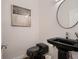 Modern half-bathroom with sleek black fixtures, a minimalist sink, and stylish decor at 338 Saint Paul St, Denver, CO 80206