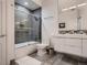 Modern bathroom with gray tile, glass shower enclosure, sleek fixtures and contemporary design at 338 Saint Paul St, Denver, CO 80206
