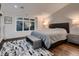 Bedroom with a large window, upholstered bench at the foot of the bed, and striking rug at 338 Saint Paul St, Denver, CO 80206