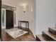 Elegant entryway featuring hardwood floors, staircase, and a modern console table at 338 Saint Paul St, Denver, CO 80206