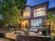 Stunning brick two-story home with a spacious patio and black iron fence at 338 Saint Paul St, Denver, CO 80206