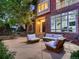 Charming front patio with modern seating, brick facade, and lush surrounding trees at 338 Saint Paul St, Denver, CO 80206