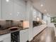 Stylish kitchen with sleek white cabinets, granite countertops, and a wine fridge at 338 Saint Paul St, Denver, CO 80206