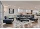 Open-concept living room with a modern sectional sofa, stylish rug, and contemporary artwork at 338 Saint Paul St, Denver, CO 80206
