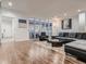 Spacious living room with a modern sofa, glass doors, and hardwood floors at 338 Saint Paul St, Denver, CO 80206
