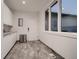 Clean mudroom with white cabinetry, gray floors, and natural light at 338 Saint Paul St, Denver, CO 80206