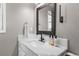 Bathroom with a white marble sink and countertop with a black faucet and black framed mirror at 3603 Soaring Eagle Ct, Castle Rock, CO 80109