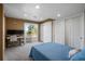 Bedroom with sliding glass doors, lots of light, and two closets at 3603 Soaring Eagle Ct, Castle Rock, CO 80109