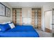 Bedroom featuring a bright blue bedspread and built-in wall shelving, desk and storage system at 3603 Soaring Eagle Ct, Castle Rock, CO 80109