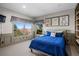 Comfortable bedroom with large windows and mountain views and decorated with dog themed art at 3603 Soaring Eagle Ct, Castle Rock, CO 80109