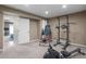 Spacious home gym with exercise equipment and neutral-toned walls and carpeting at 3603 Soaring Eagle Ct, Castle Rock, CO 80109