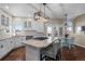 Bright kitchen features stainless steel appliances, granite counters, island with seating, breakfast nook and backyard access at 3603 Soaring Eagle Ct, Castle Rock, CO 80109