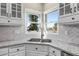 Close up on the kitchen sink looking out towards the water through the bright corner windows at 3603 Soaring Eagle Ct, Castle Rock, CO 80109