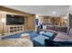 Open concept living room with sofa, bean bag chair, and television, great for entertaining at 3603 Soaring Eagle Ct, Castle Rock, CO 80109