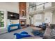 Open-concept living room with brick fireplace and view of second story at 3603 Soaring Eagle Ct, Castle Rock, CO 80109