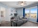 Cozy living room with mountain views, large windows, and desk setup at 3603 Soaring Eagle Ct, Castle Rock, CO 80109