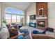 Inviting living room with brick fireplace, large windows, and comfortable seating at 3603 Soaring Eagle Ct, Castle Rock, CO 80109
