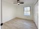 Well-lit bedroom with wood-look floors and a large window at 4899 S Dudley # 1I, Littleton, CO 80123