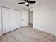 Bright bedroom featuring wood-look floors and double door closet at 4899 S Dudley # 1I, Littleton, CO 80123
