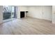 Bright living room with wood-look floors and sliding glass door to patio at 4899 S Dudley # 1I, Littleton, CO 80123