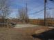 A spacious backyard with a bench and partial fence, ready for new landscaping and outdoor enjoyment at 5660 Olive St, Commerce City, CO 80022