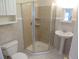 Bathroom featuring a glass-enclosed shower, pedestal sink, and tiled walls at 5660 Olive St, Commerce City, CO 80022