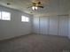 Bedroom featuring carpet floors, a ceiling fan, and multiple closet spaces for ample storage at 5660 Olive St, Commerce City, CO 80022