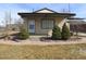 Charming single story home with a covered porch and landscaped front yard in a quiet neighborhood at 5660 Olive St, Commerce City, CO 80022