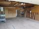 Spacious garage with lift, storage, heater, and side door access; ideal for projects or storage at 5660 Olive St, Commerce City, CO 80022