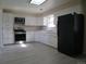 Well-maintained kitchen with white cabinets, stainless steel appliances, and a light-filled skylight at 5660 Olive St, Commerce City, CO 80022