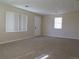 Bright and airy living room with neutral walls, new carpet, and two large windows with views of the exterior at 5660 Olive St, Commerce City, CO 80022