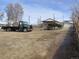 A wide view of the house, garage, and large open lot, creating numerous possibilities at 5660 Olive St, Commerce City, CO 80022
