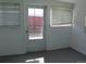 Enclosed sunroom with neutral walls, windows, and an exterior door at 5660 Olive St, Commerce City, CO 80022