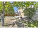 Backyard featuring deck with pergola, mature trees, and wood fence at 12616 Country Meadows Dr, Parker, CO 80134